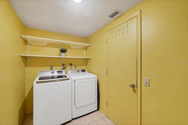 217 High Point Dr Unit 217A, Englewood, FL 34223 - laundry area with independent washer and dryer and light tile patterned floors