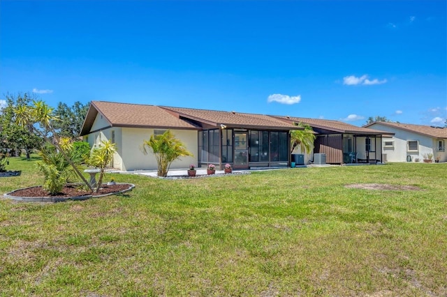 217 High Point Dr Unit 217A, Englewood, FL 34223 - rear view of property featuring a yard, a sunroom, and stucco siding