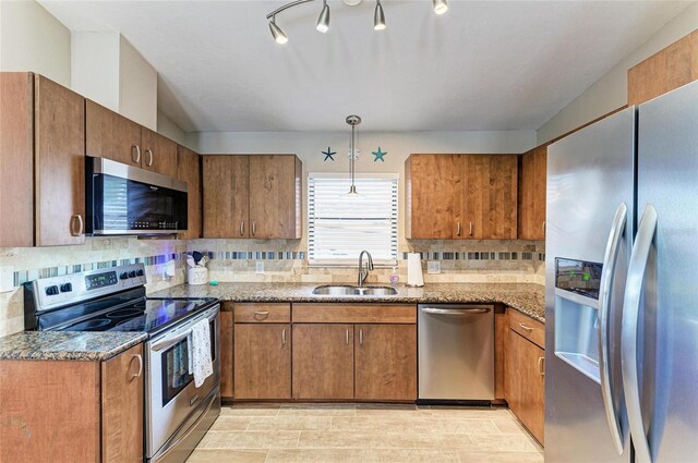 4115 2nd Ave NW, Bradenton, FL 34209 - kitchen featuring appliances with stainless steel finishes, a sink, brown cabinetry, and tasteful backsplash