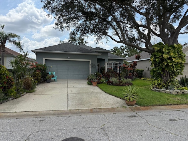 817 Tallgrass Ln, Bradenton, FL 34212 - view of front of home featuring stucco siding, a garage, concrete driveway, and a front yard