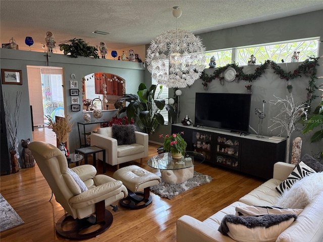 817 Tallgrass Ln, Bradenton, FL 34212 - living area with a textured ceiling, a chandelier, and wood finished floors