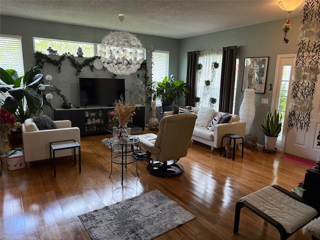 817 Tallgrass Ln, Bradenton, FL 34212 - living area featuring hardwood / wood-style flooring, a chandelier, healthy amount of natural light, and a textured ceiling