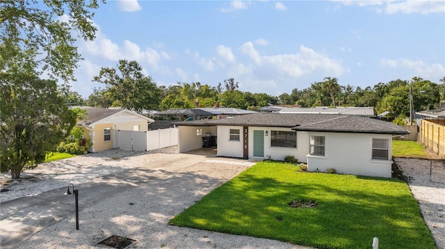 2715 Herwald St, Sarasota, FL 34231 - view of front facade with driveway, a carport, a shingled roof, and a gate