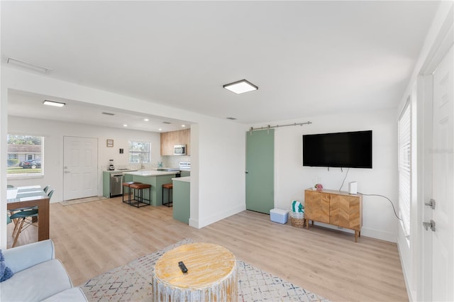 2715 Herwald St, Sarasota, FL 34231 - living area with light wood finished floors, baseboards, and recessed lighting