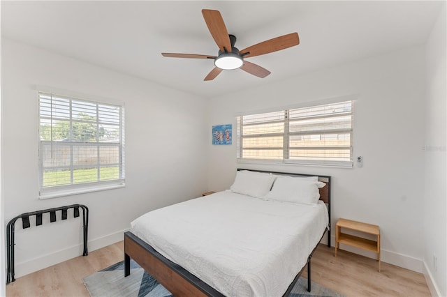 2715 Herwald St, Sarasota, FL 34231 - bedroom with multiple windows, light wood-style floors, and baseboards