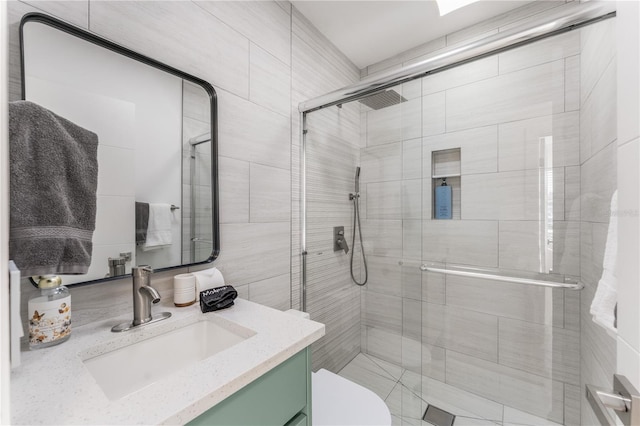 2715 Herwald St, Sarasota, FL 34231 - full bath with a shower stall, vanity, toilet, and tile walls