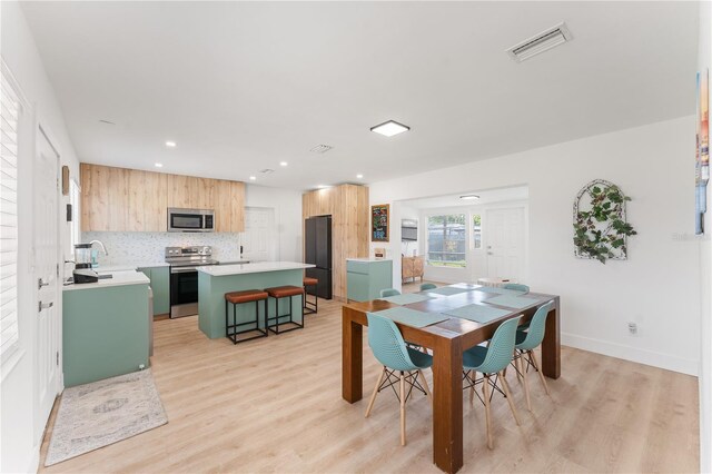 2715 Herwald St, Sarasota, FL 34231 - dining area with light wood finished floors, recessed lighting, and baseboards