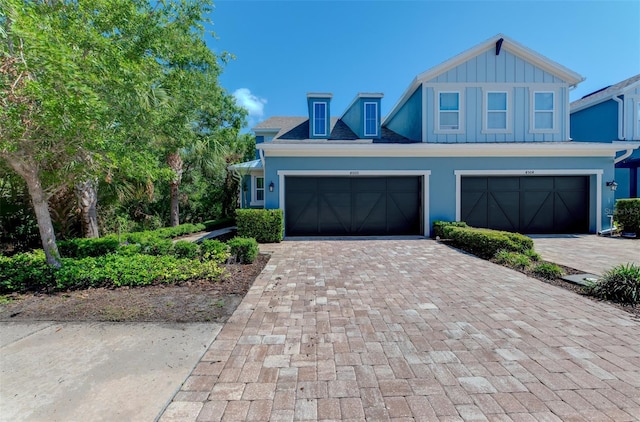 4500 Chinkapin Dr, Sarasota, FL 34232 - view of front of property with decorative driveway, board and batten siding, and stucco siding