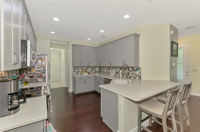 4500 Chinkapin Dr, Sarasota, FL 34232 - kitchen with a sink, stainless steel appliances, gray cabinetry, dark wood-style floors, and recessed lighting
