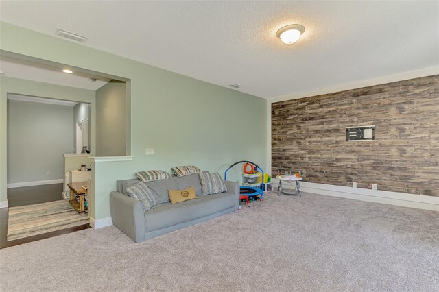 4500 Chinkapin Dr, Sarasota, FL 34232 - playroom with carpet flooring, wood walls, a textured ceiling, baseboards, and an accent wall