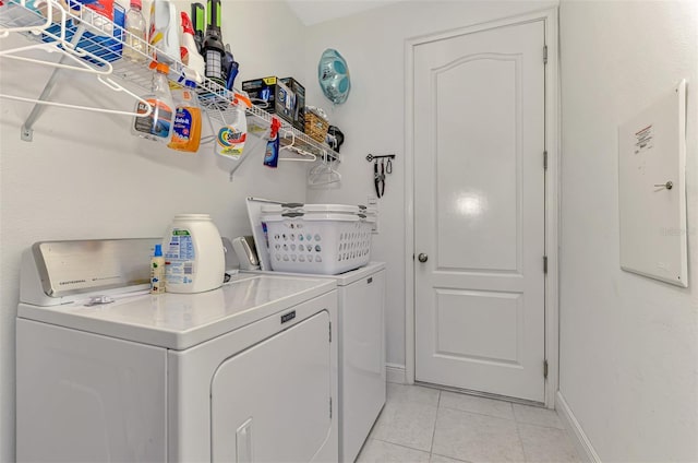 4500 Chinkapin Dr, Sarasota, FL 34232 - clothes washing area with separate washer and dryer, light tile patterned floors, and baseboards