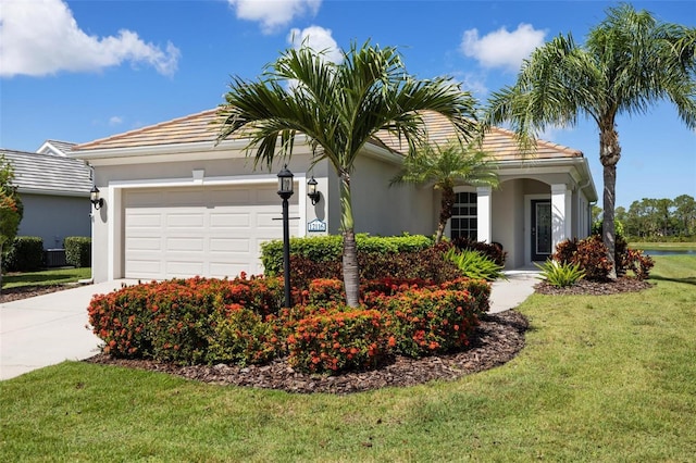 ranch-style home featuring stucco siding, an attached garage, driveway, and a tile roof