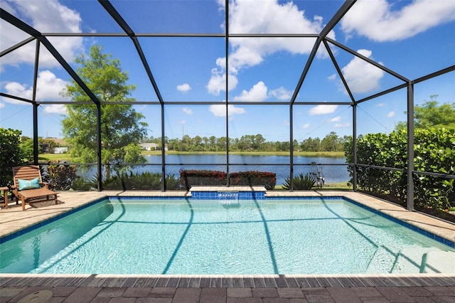 outdoor pool featuring a water view, glass enclosure, and a patio