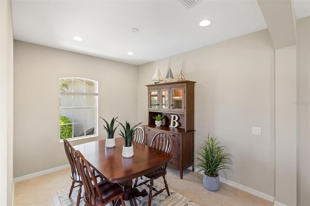 dining room featuring light tile patterned floors, recessed lighting, and baseboards
