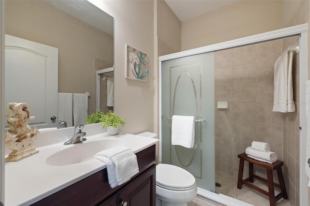 full bath featuring a stall shower, vanity, and toilet
