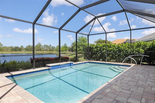 outdoor pool featuring a water view, glass enclosure, and a patio