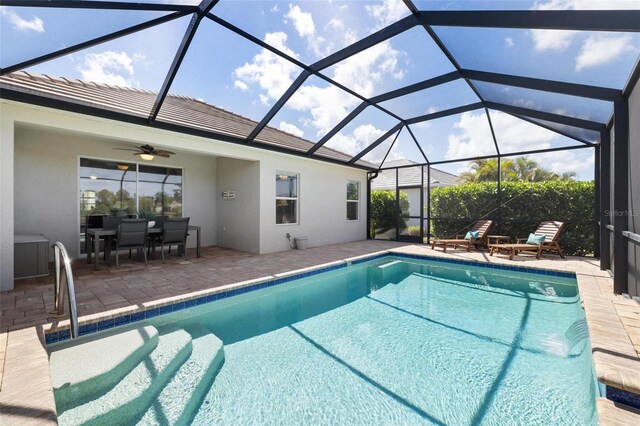 swimming pool with a patio area, ceiling fan, and outdoor dining space