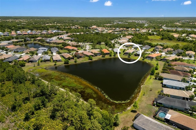 aerial view of property and surrounding area with nearby suburban area and a large body of water