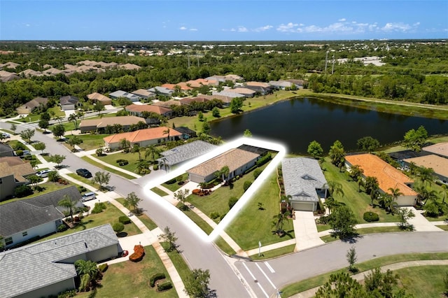 aerial view of residential area featuring a large body of water