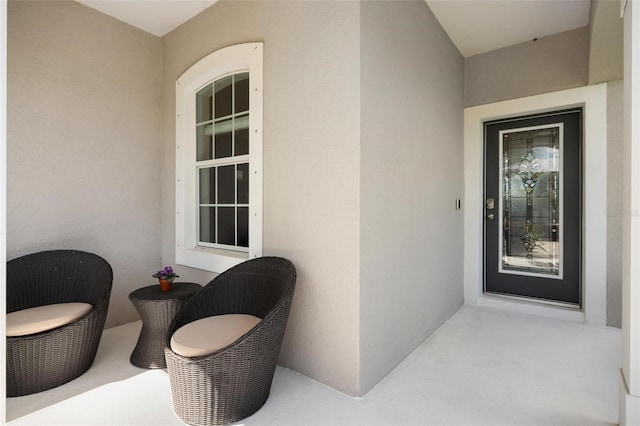 property entrance with stucco siding