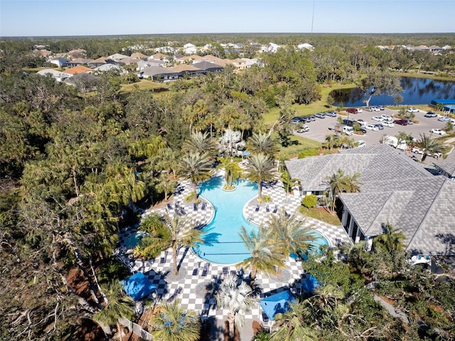 aerial view of a pool area and a large body of water