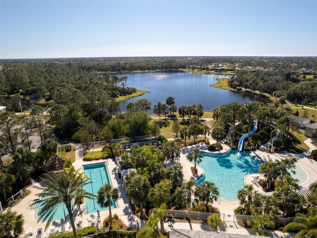 aerial view of a pool area and a nearby body of water