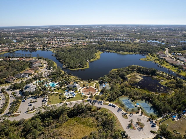 aerial view of property and surrounding area featuring a nearby body of water and nearby suburban area