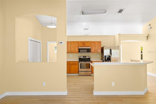 1399 Shields St, Punta Gorda, FL 33980 - kitchen featuring stainless steel appliances, light wood-style flooring, arched walkways, and light countertops