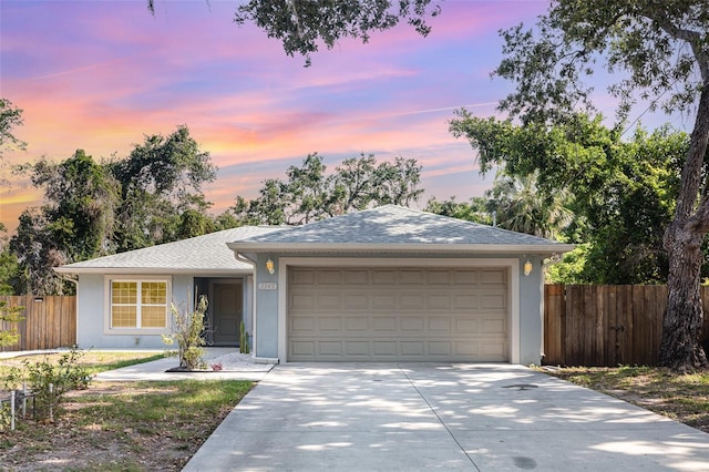 1345 24th St, Sarasota, FL 34234 - ranch-style home with driveway, an attached garage, and stucco siding