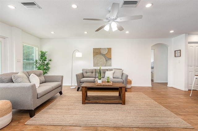 1345 24th St, Sarasota, FL 34234 - living room with arched walkways, wood finished floors, recessed lighting, ceiling fan, and baseboards