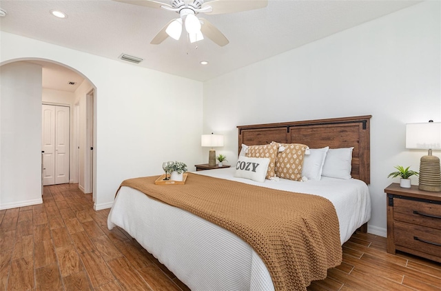 1345 24th St, Sarasota, FL 34234 - bedroom featuring arched walkways, wood finished floors, baseboards, ceiling fan, and recessed lighting