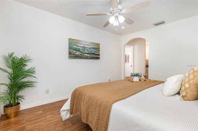 1345 24th St, Sarasota, FL 34234 - bedroom featuring wood finished floors, arched walkways, baseboards, recessed lighting, and ceiling fan