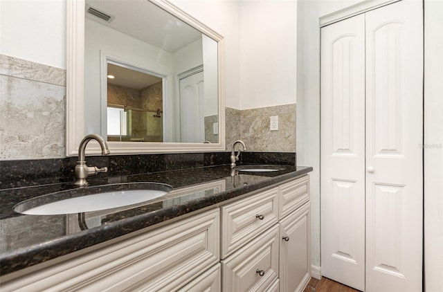 1345 24th St, Sarasota, FL 34234 - full bathroom with a closet, double vanity, and an enclosed shower