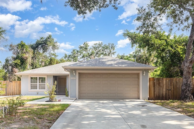 1345 24th St, Sarasota, FL 34234 - ranch-style home with stucco siding, concrete driveway, and a garage