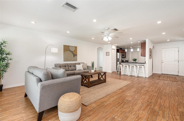 1345 24th St, Sarasota, FL 34234 - living area featuring arched walkways, light wood-style floors, recessed lighting, and a ceiling fan
