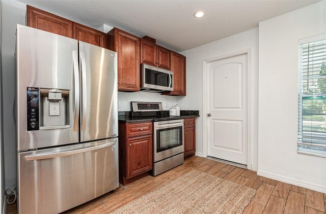 1345 24th St, Sarasota, FL 34234 - kitchen featuring appliances with stainless steel finishes, light wood-style floors, recessed lighting, and a textured ceiling