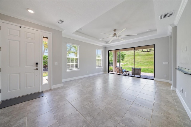 6250 Grandview Hill Ct, Bradenton, FL 34203 - entrance foyer with ceiling fan, baseboards, a tray ceiling, light tile patterned flooring, and ornamental molding