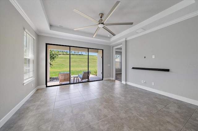 6250 Grandview Hill Ct, Bradenton, FL 34203 - spare room featuring a tray ceiling, plenty of natural light, ceiling fan, and ornamental molding