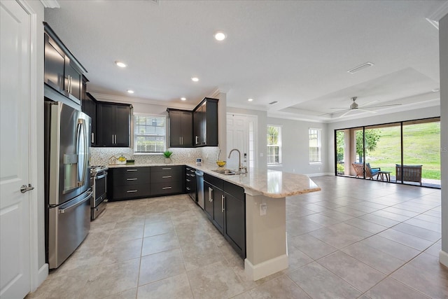 6250 Grandview Hill Ct, Bradenton, FL 34203 - kitchen featuring stainless steel appliances, a sink, a peninsula, open floor plan, and decorative backsplash