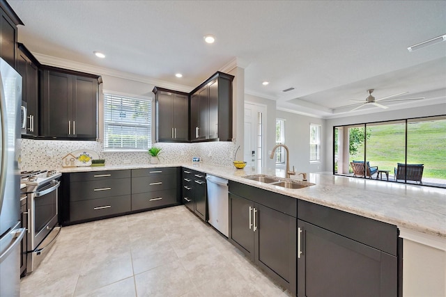 6250 Grandview Hill Ct, Bradenton, FL 34203 - kitchen with a sink, stainless steel appliances, backsplash, ornamental molding, and light stone counters