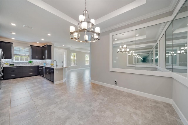 6250 Grandview Hill Ct, Bradenton, FL 34203 - kitchen with a tray ceiling, a chandelier, open floor plan, baseboards, and crown molding