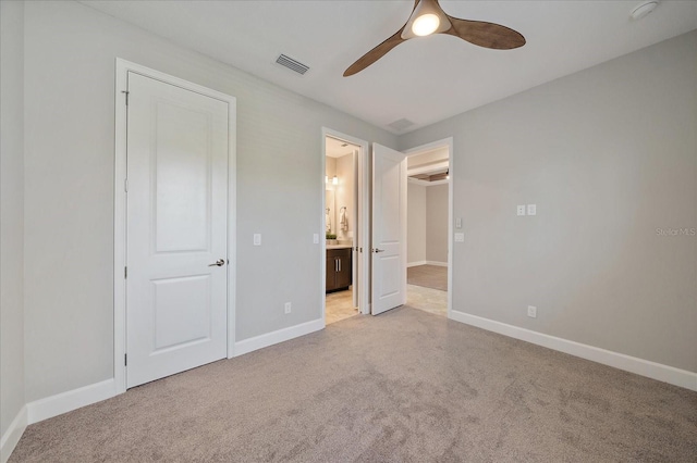 6250 Grandview Hill Ct, Bradenton, FL 34203 - unfurnished bedroom with light carpet, ensuite bathroom, baseboards, and a ceiling fan