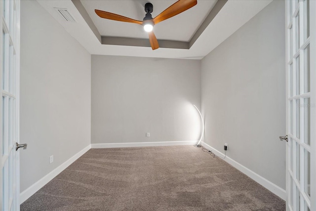 6250 Grandview Hill Ct, Bradenton, FL 34203 - empty room with carpet floors, ceiling fan, baseboards, and a raised ceiling