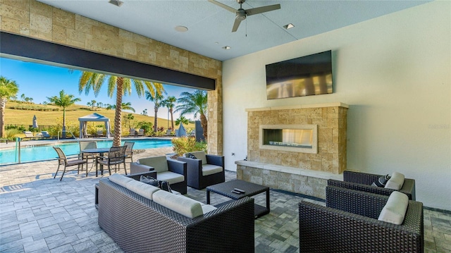 6250 Grandview Hill Ct, Bradenton, FL 34203 - view of patio with a ceiling fan, an outdoor living space with a fireplace, a gazebo, and an outdoor pool
