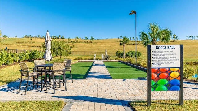 6250 Grandview Hill Ct, Bradenton, FL 34203 - view of patio / terrace with a bocce ball area, fence, and a view of countryside