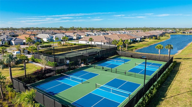 6250 Grandview Hill Ct, Bradenton, FL 34203 - view of tennis court featuring fence, a residential view, and a water view