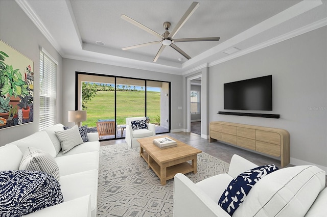 6250 Grandview Hill Ct, Bradenton, FL 34203 - living room featuring a raised ceiling, ceiling fan, crown molding, light tile patterned flooring, and baseboards