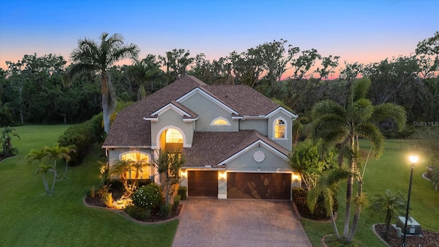6907 47th Ct E, Ellenton, FL 34222 - traditional home featuring a front lawn, concrete driveway, stucco siding, and an attached garage