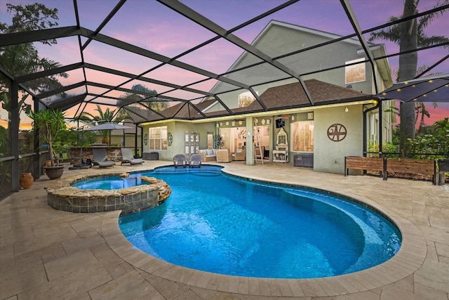 6907 47th Ct E, Ellenton, FL 34222 - pool at dusk featuring a patio, a pool with connected hot tub, and glass enclosure