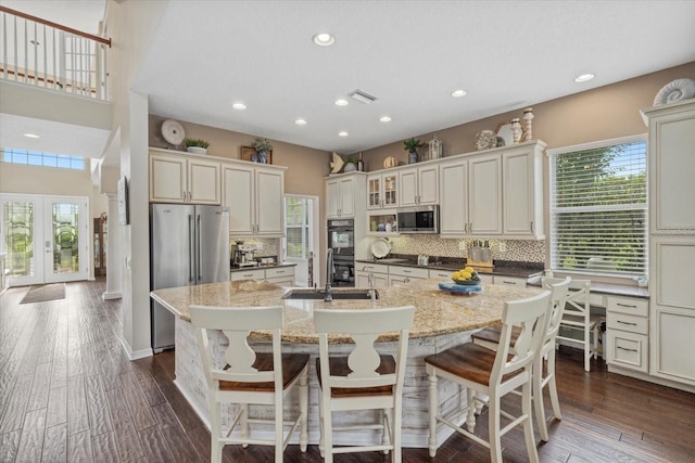6907 47th Ct E, Ellenton, FL 34222 - kitchen featuring stainless steel appliances, recessed lighting, backsplash, a kitchen island with sink, and dark wood-style floors